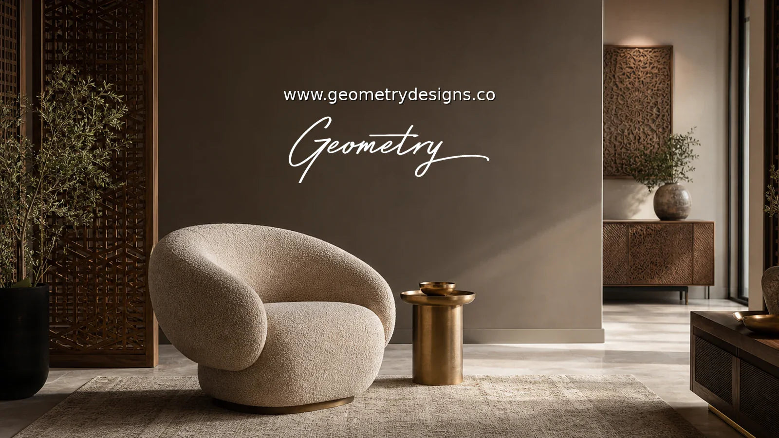 Geometry Designs statement accent chair anchoring a modern Indian luxury living room with rug, brass side table, carved wood details, real Geometry wordmark, and www.geometrydesigns.co.
