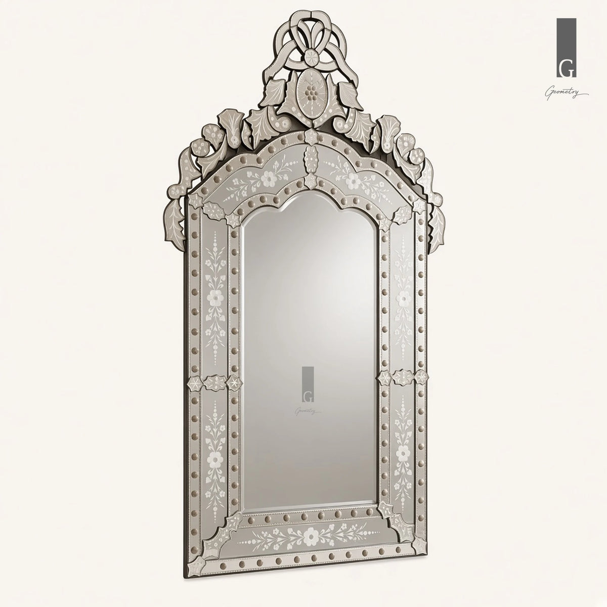 Geometry Designs Venetian Mirror in etched silver glass, shown at a three-quarter angle on an ivory background.