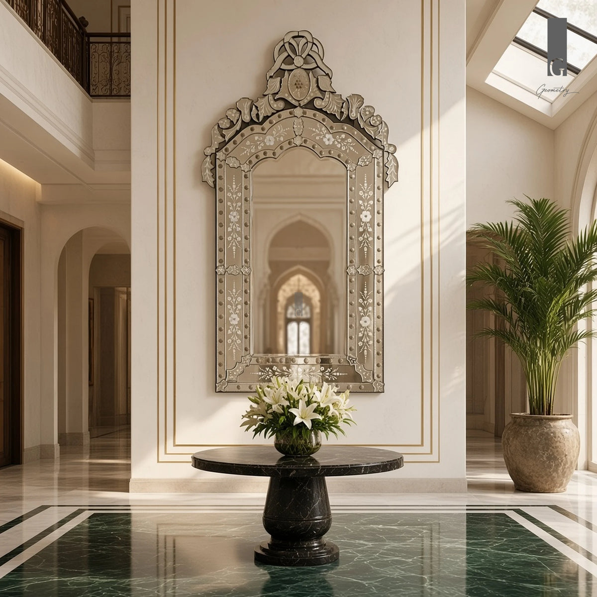 Geometry Designs Venetian Mirror in etched silver glass, shown above a black stone pedestal table in a green-marble modern Indian foyer.