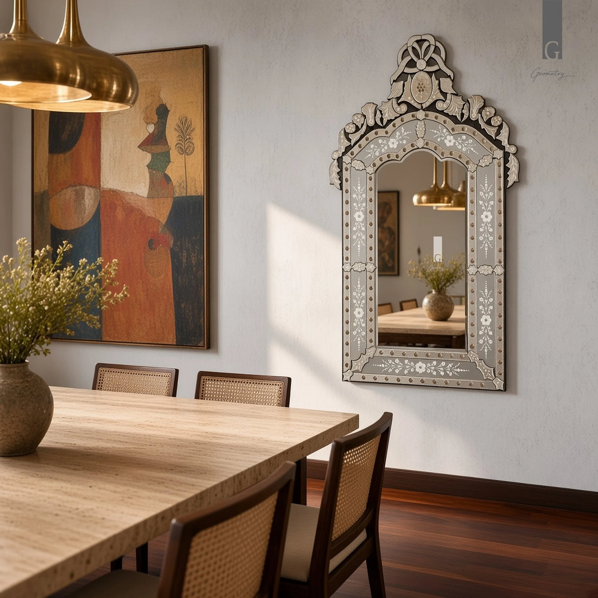 Geometry Designs Venetian Mirror in etched silver glass, shown in a modern Indian dining room with travertine table and cane chairs.