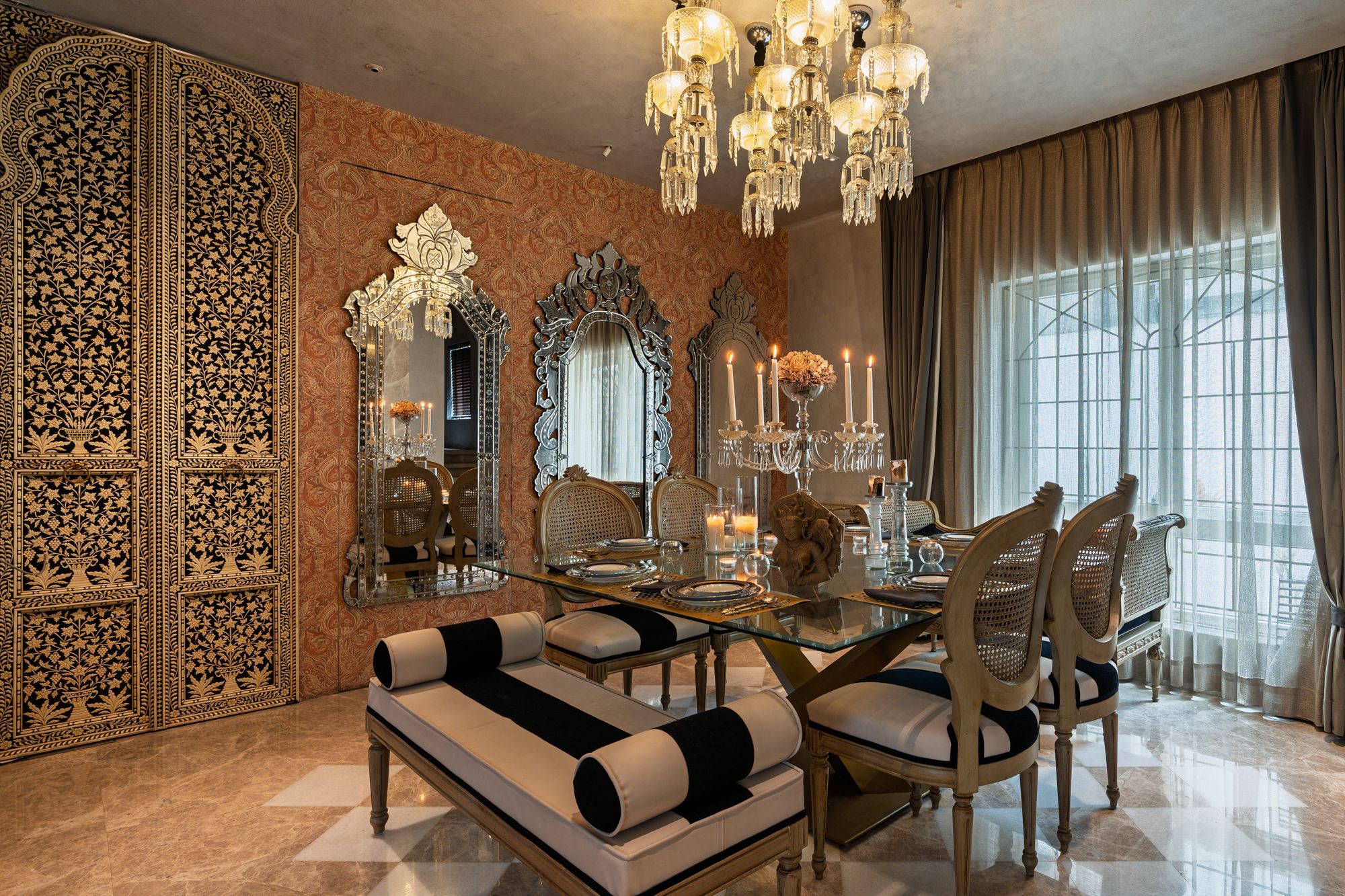 Villa 78 dining room with Venetian mirrors and a crystal chandelier